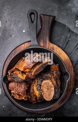 De courtes côtes de bœuf tendres dans une poêle, assaisonnées d'herbes et d'épices. Parfait pour les blogs culinaires ou les menus de restaurant qui se concentrent sur la viande copieux et savoureux d Banque D'Images