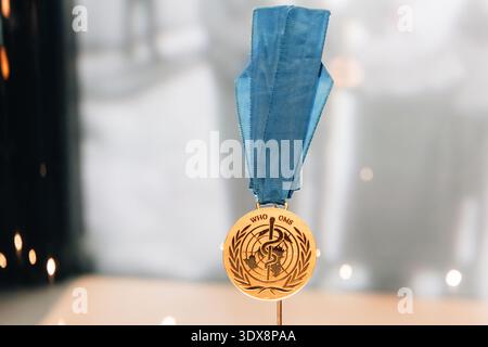 6 décembre 2025, Abu Dhabi, Émirats arabes Unis : médaille de l'Organisation mondiale de la santé - OMS, représentant le symbole d'Asclépius et une carte du monde Banque D'Images