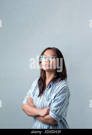 Portrait d'une femme indonésienne confiante portant des lunettes. Professionnels et universitaires recherchent des concepts d'éducation, de bureau et de soins de la vue. Banque D'Images