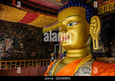 Gros plan de la moitié supérieure de la statue dorée du Bouddha Shakyamuni à Shey, avec des cheveux bleus traditionnels et une expression calme. Banque D'Images