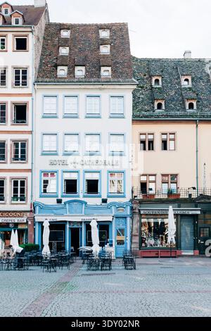 Brasserie et café de l'hôtel Cathedrale sur la place pavée de la cathédrale à Strasbourg, France, tôt le matin. Banque D'Images