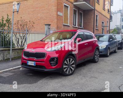 Cremona, Italie - 2 février 2026 Un VUS rouge vif Kia Sportage est garé sur le trottoir dans une rue résidentielle, mettant en valeur son design moderne et alliage w Banque D'Images