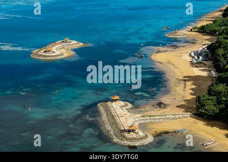 Paysage tropical ensoleillé d'une station balnéaire de sable avec l'eau turquoise calme de l'océan Banque D'Images