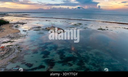 Vue aérienne par drone de Sanur, côte de Bali au crépuscule avec le mont Agung à distance Banque D'Images