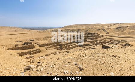 D'anciennes ruines de pierre et des fouilles en terrasses s'étendent à travers un paysage désertique ensoleillé près de la pyramide de Djéser spet, au Caire en Égypte, évoquant des archéols Banque D'Images