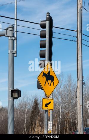 Photo verticale du panneau d'avertissement jaune de passage de cavalier sur la voie publique régulière, symbole de trafic équestre, concept de sécurité des transports Banque D'Images