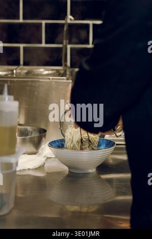 Le processus de cuisson des ramen dans une cuisine de restaurant Banque D'Images