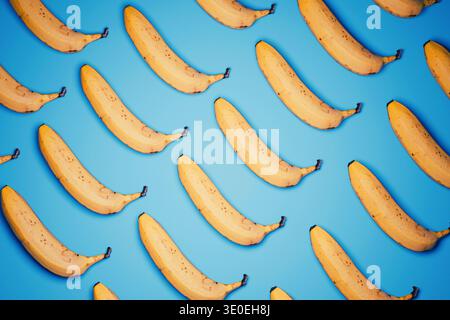 Un motif vibrant de haut en bas de bananes jaunes mûres disposées en diagonale sur un fond bleu vif. Style pop art minimaliste avec des textures réalistes, h. Banque D'Images