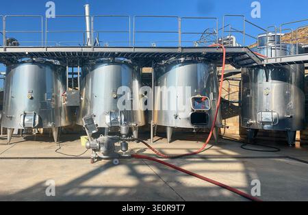Venets, Bulgarie -08 octobre 2024 : les cuves en acier inoxydable pour la fermentation du vin sont disposées avec des tuyaux et une plate-forme surélevée dans un environnement viticole Banque D'Images