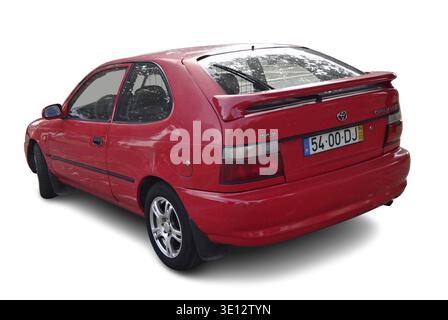 Red Toyota Corolla hayon garé, transportant des personnes ou représentant la propriété personnelle Banque D'Images