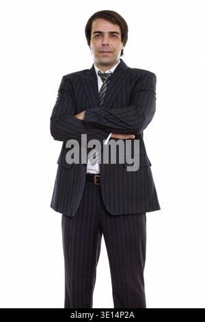 Studio shot of young businessman Persique standing with arms crossed Banque D'Images