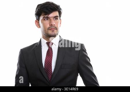Studio shot of young businessman thinking Persan tout en regardant à distance Banque D'Images