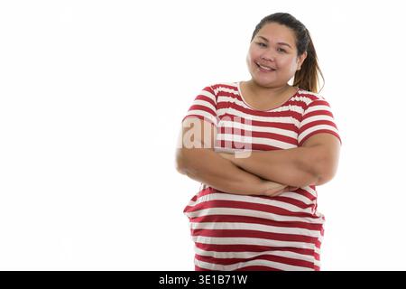 Studio shot of young woman smiling happy fat with arms crossed Banque D'Images
