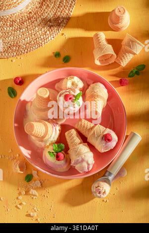 Délicieuse et sucrée glace à la framboise dans un cornet de gaufre. Crème glacée à base de crème et de framboises. Banque D'Images
