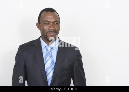 Photo en studio d'un homme d'affaires africain barbu sur fond blanc Banque D'Images