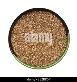 Vue de dessus des graines de teff de grains entiers dans un bol rond isolé sur fond blanc Banque D'Images