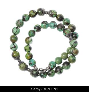 Top view of coiled antique arabic necklace from polished turquoise and silver beads isolated on white background Banque D'Images