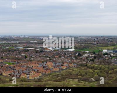 Vue aérienne du logement de Middlesbrough et de la zone industrielle portuaire avec des éoliennes et le littoral montrant le contraste entre les rues résidentielles et HE Banque D'Images
