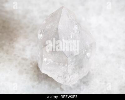 Plan macro d'un échantillon de roche naturelle quartz gemme cristal de roche sur fond de marbre blanc Banque D'Images