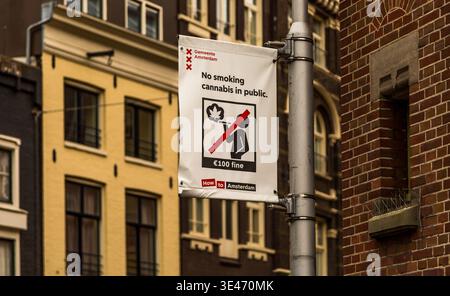 Un panneau « cannabis interdit de fumer en public » monté sur un lampadaire dans le centre d'Amsterdam avec un bâtiment en arrière-plan Banque D'Images