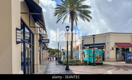 West Palm Beach FL, États-Unis - 05 mars 2026 : zone commerçante avec vitrine et palmiers Vans, présentant des publicités colorées et un ciel bleu clair i. Banque D'Images