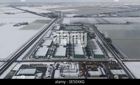Vue aérienne du centre de données Agriport A7 entouré de champs enneigés et de serres industrielles à Middenmeer, Noord-Holland, Netherlan Banque D'Images