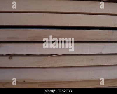Les planches de bois empilées affichent des motifs de grain naturel et des textures dans un cadre de jardin de bois Banque D'Images