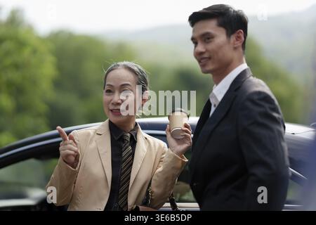 Portrait de la femme d'affaires senior asiatique et jeune homme d'affaires discutant au sujet du projet immobilier Banque D'Images
