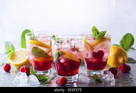 Limonade aux framboises en verres avec baies fraîches et feuilles de menthe Banque D'Images