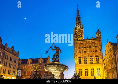 Gdansk, Pologne - 2 mai 2025 : Fontaine de Neptune avec l'hôtel de ville principal sur la place du long marché. Fontaine de Neptune à Gdansk, Pologne, au crépuscule. A Banque D'Images