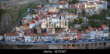 Porto, Portugal - avril 22,2024 : quartier de Porto Ribeira avec des bâtiments historiques colorés sur une colline surplombant une route Banque D'Images