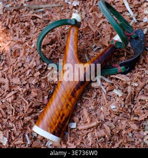 Slingshot est fabriqué à partir de bois de rose rayé de tigre sur un fond de sciure de bois Banque D'Images