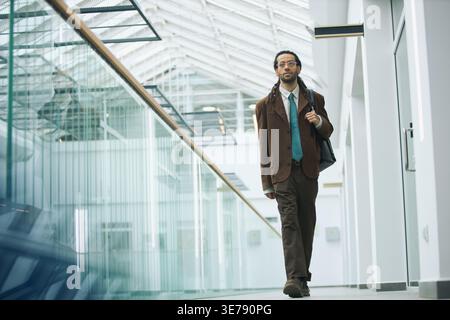 Portrait d'homme d'affaires adulte marchant dans le bureau moderne Banque D'Images
