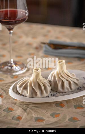 Boulettes de khinkali avec du vin sur la table du restaurant Banque D'Images