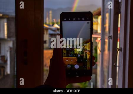 Srinagar, Inde. 11 avril 2026. Un homme prend des photos d'arc-en-ciel à Srinagar, la capitale estivale du Jammu-et-Cachemire. Crédit : SOPA images Limited/Alamy Live News Banque D'Images