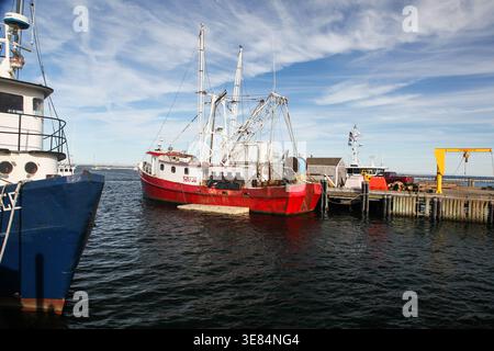 PROVINCETOWN, MASSACHUSETTS, USA -14 SEPTEMBRE 2014 : bateaux de pêche amarrés à un quai de port sous un ciel bleu avec des nuages blancs Banque D'Images