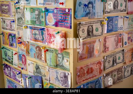 Zurich, Suisse - 2 avril 2026 : billets de banque internationaux épinglés sur un mur, affichage coloré de collection d'argent avec punaises, voyage Banque D'Images
