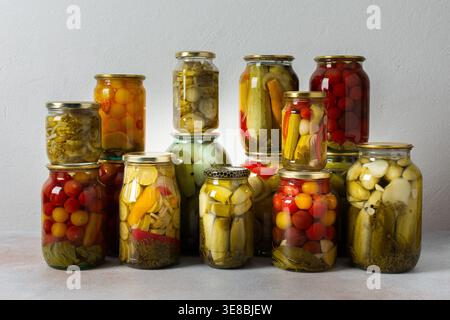 La mise en conserve est une activité courante dans la cuisine car des bocaux remplis de légumes et de fruits bordent le comptoir. Cette pratique aide à préserver la nourriture pour gagner Banque D'Images