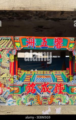 Taichung, Taiwan - 26 mai 2024 : Xiang Wu Zhou gant troupe de marionnettes en toile de fond par Zhong Chengming avec dragons mythiques sur une scène de temple. Banque D'Images