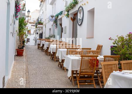 Charmante scène de rue Altea invitant les voyageurs à manger en plein air dans un café en Espagne, parfait pour des vacances en famille et des vacances reposantes Banque D'Images
