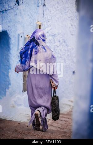 Portrait d'une jeune femme avec le hijab marchant dans les rues bleues de Chefchaouen, Maroc Banque D'Images