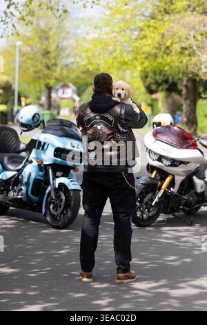 À USAGE ÉDITORIAL EXCLUSIF Kian, un Golden Retriever âgé de dix semaines, rencontre le pilote Harley-Davidson Dave Brace à Kidderminster, alors que l'association caritative Guide Dogs appelle davantage de motards à se porter volontaires pour élever des chiots. Date d'émission : mercredi 22 avril 2026. Banque D'Images