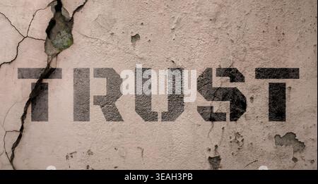 Word Trust et fissures sur le mur. Trahison Banque D'Images