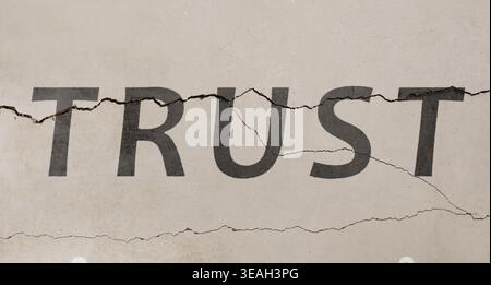 Word Trust et fissures sur le mur. Trahison Banque D'Images