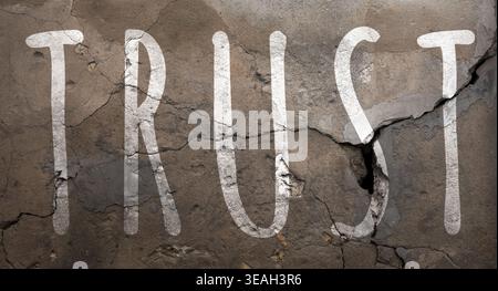 Word Trust et fissures sur le mur. Trahison Banque D'Images