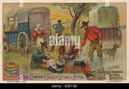 Série de photos du Transvaal, scène de mineurs d'or et de colons avec des wagons couverts dans le Transvaal, Afrique du Sud. Des hommes cuisinant au-dessus d'un feu de camp et une femme à côté d'un wagon couvert sont visibles. Liebig image, reproduction restaurée numériquement d'une carte de collection datant d'environ 1900, date exacte inconnue. Banque D'Images