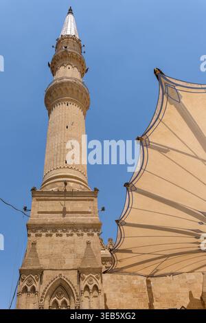 Vue sur la mosquée Imam Al-Hussein avec son grand minaret en pierre et son pare-soleil moderne sous un ciel bleu clair le Caire, Egypte. Banque D'Images