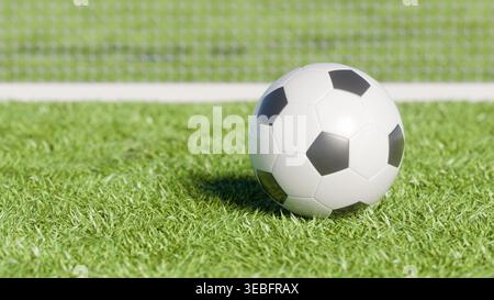 Rendu 3D d'un ballon de football noir et blanc classique sur un terrain d'herbe verte avec un fond de filet de stade flou. Concept de match de football, sport com Banque D'Images