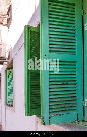 Gros plan d'un volet de fenêtre à persiennes en bois vert sur un vieux bâtiment à Paphos, Ciprus. Mise au point sélective et espace de copie. Banque D'Images