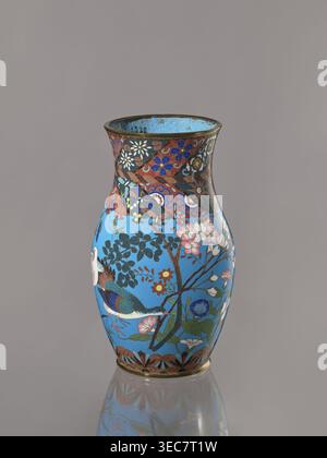 Vase, colombes, fleurs, art japonais ; culture japonaise. Oiseaux, Meiji 1868–1912, lis, émail cloisonné, chrysanthèmes, wolfberries, sakura, papillons, libellules, kachôga. Vase avec un col épais, séparé vers le bec. Émail cloisonné sur cuivre. Le bec verseur et le pied sont entourés par des anneaux en laiton. Vers 1870–1880 période Meiji, Japon, Nagoya. Récipient ; hauteur 26,5 cm, largeur 15,5 cm., Un vase unique orné repose sur un fond gris Uni, sa forme se rétrécissant au niveau du cou et s'élargissant au niveau du corps, avec une surface réfléchissante à sa base. Le vase affiche un champ bleu vif décoré de fleurs Banque D'Images